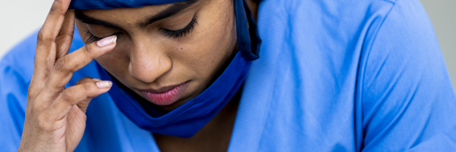 A young female doctor, looking overwhelmed