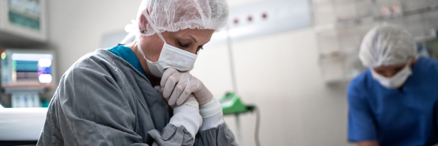 Two tired-looking doctors sitting in an operating room