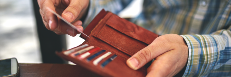 A man taking his health card out of his wallet