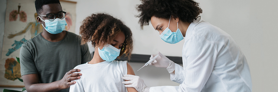 Girl receiving vaccine injection in left arm