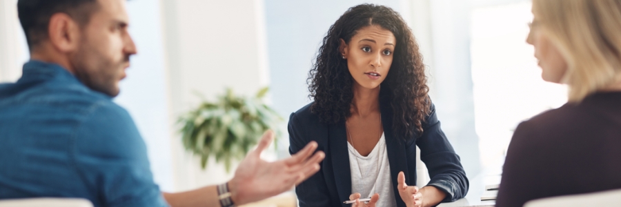 A female physician counselling two family members