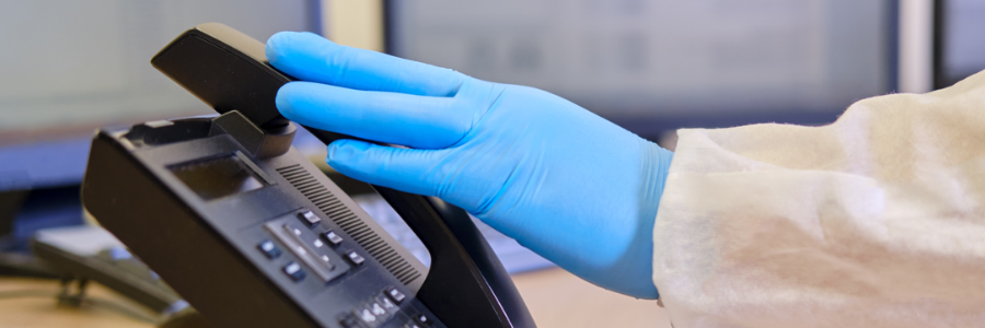 Close-up of doctor’s hand on telephone