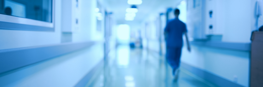 A doctor walking down a hospital corridor