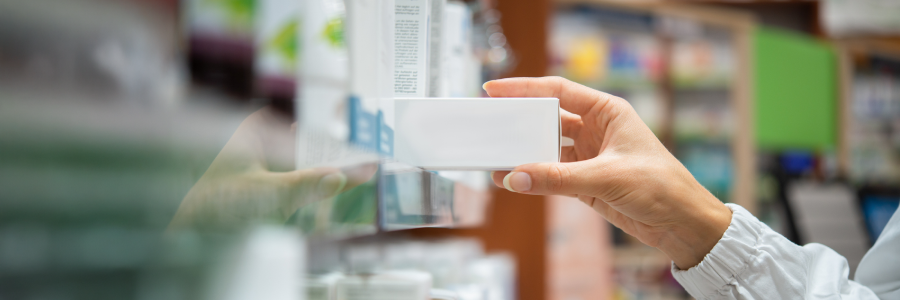 A pharmacist’s hand reaching for a prescription
