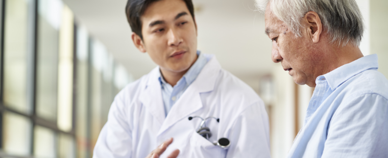 Young male physician having a conversation with a male patient.