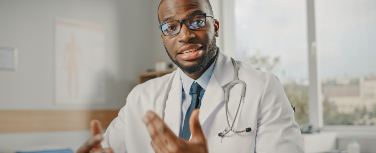 Black male physician talking to camera.