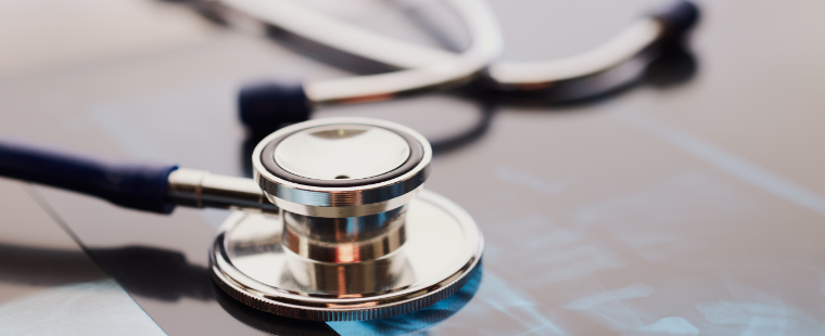 Un stéthoscope posé sur une tablette affichant des dossiers médicaux
