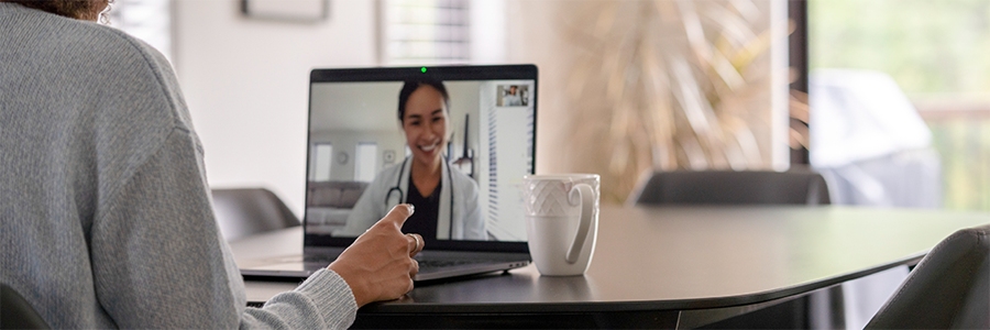 Patient attending a virtual appointment by video with a female physician.