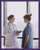 Physician speaking with healthcare team member