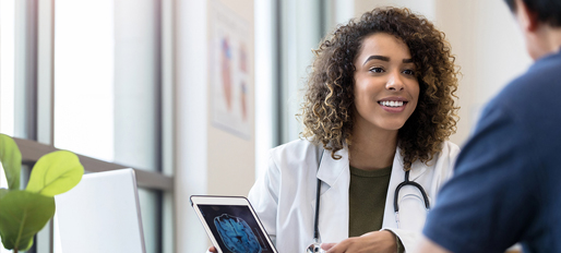 Smiling female physician showing her patient his MRI results.