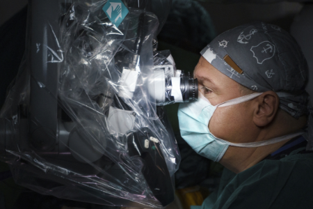 A neurosurgeon using a surgical microscope.