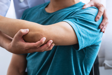 A physician assessing a patient’s arm issue
